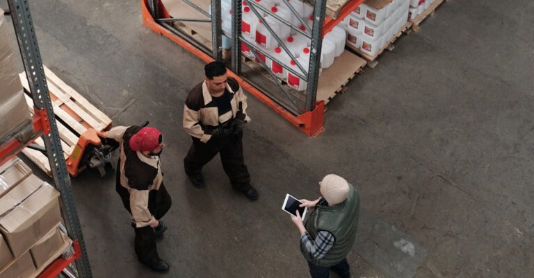 Workers discuss logistics in a busy warehouse setting, enhancing teamwork and efficiency.